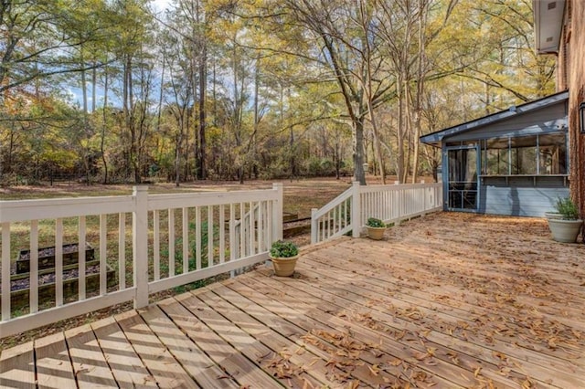 wooden deck featuring a sunroom