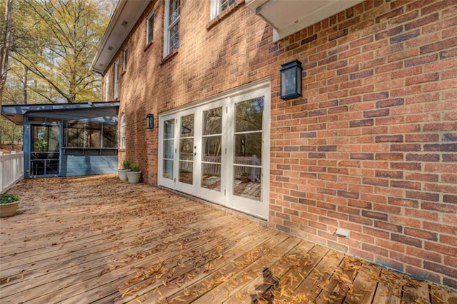 deck featuring a sunroom and french doors