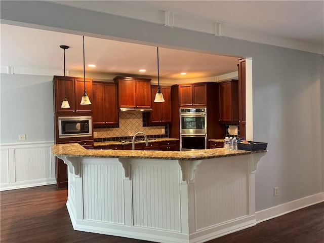 kitchen featuring stainless steel double oven, built in microwave, dark stone counters, dark wood-style floors, and tasteful backsplash