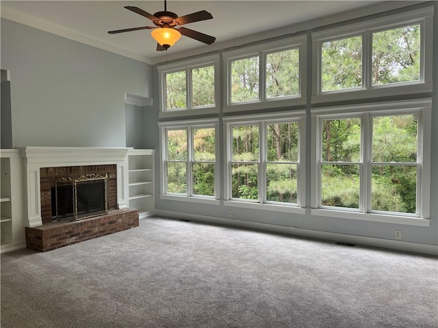 unfurnished living room featuring carpet flooring, a ceiling fan, and a fireplace