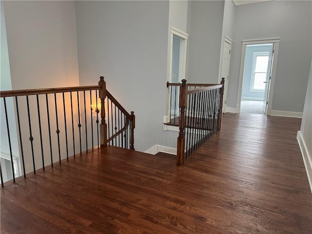 stairs featuring wood finished floors and baseboards