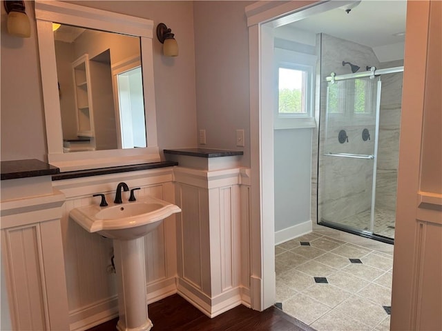 bathroom featuring a shower stall and a sink