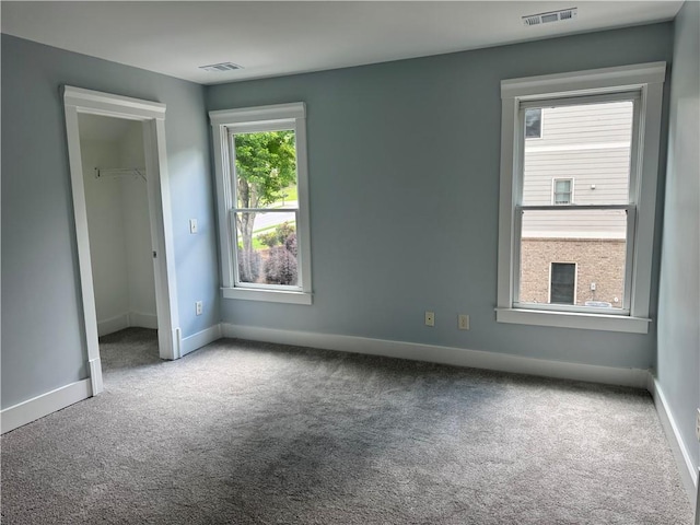 unfurnished bedroom with carpet floors, baseboards, and a closet