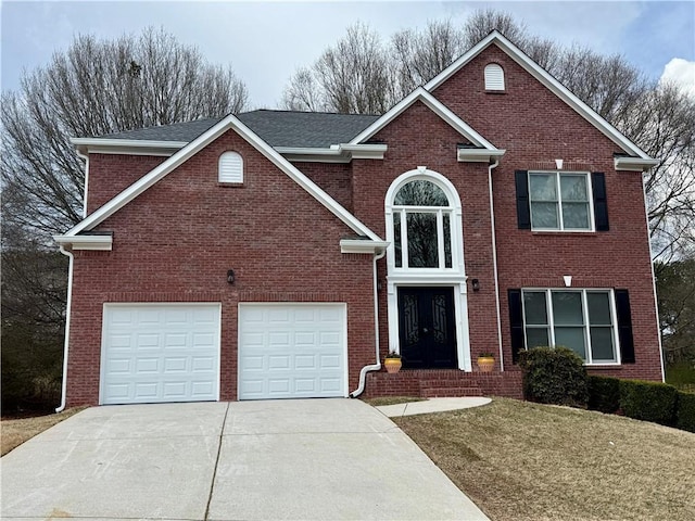 traditional home with a garage, a front yard, brick siding, and driveway