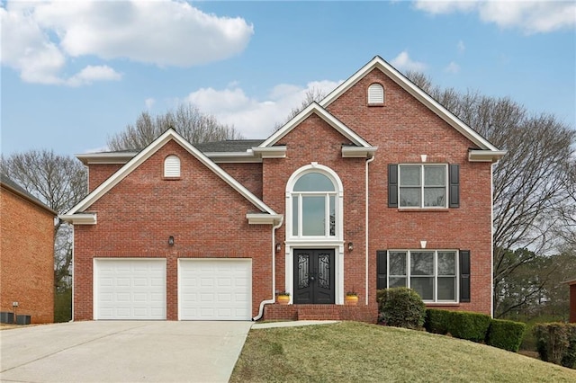 traditional-style house featuring brick siding, an attached garage, concrete driveway, and a front yard