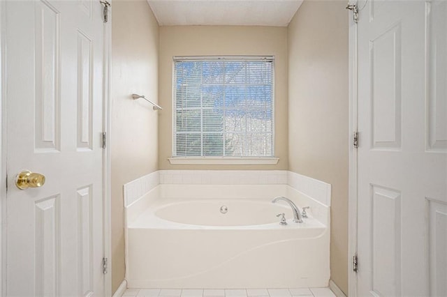 bathroom featuring a washtub and tile patterned floors