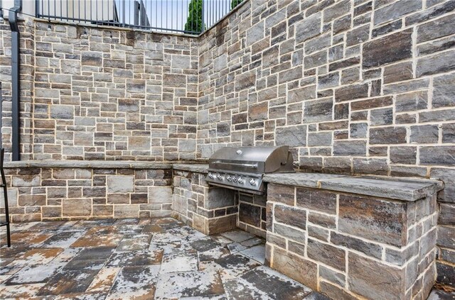 view of patio with area for grilling and an outdoor kitchen