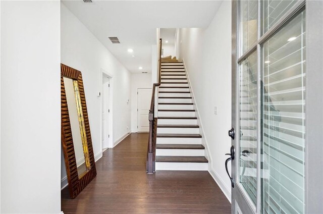 staircase with hardwood / wood-style floors