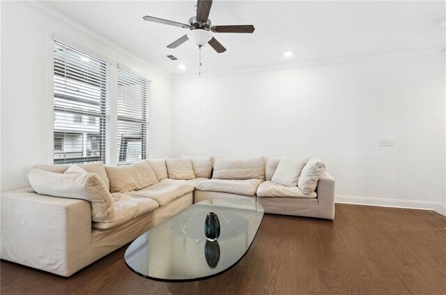 living room featuring ornamental molding, ceiling fan, and dark wood-type flooring