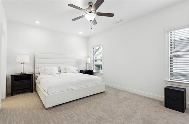 bedroom featuring ceiling fan and light carpet