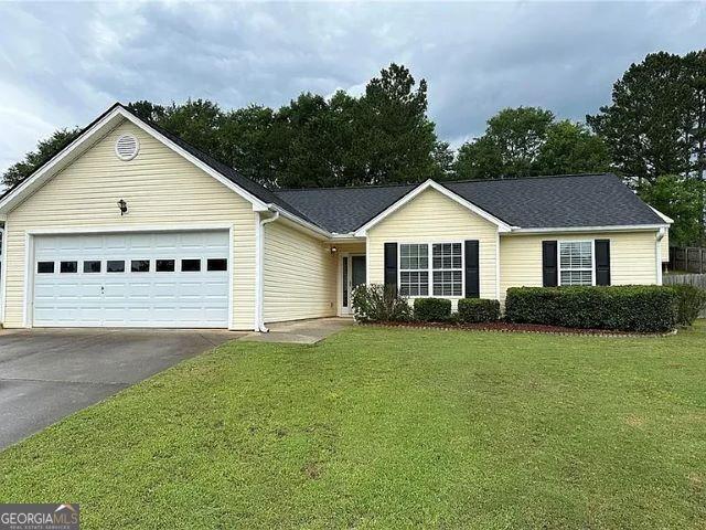 929 Wexford Way, Auburn, GA 30011 - single story home featuring concrete driveway, a garage, and a front lawn