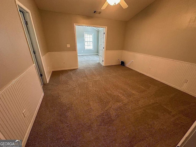929 Wexford Way, Auburn, GA 30011 - spare room featuring wainscoting, dark colored carpet, and a ceiling fan