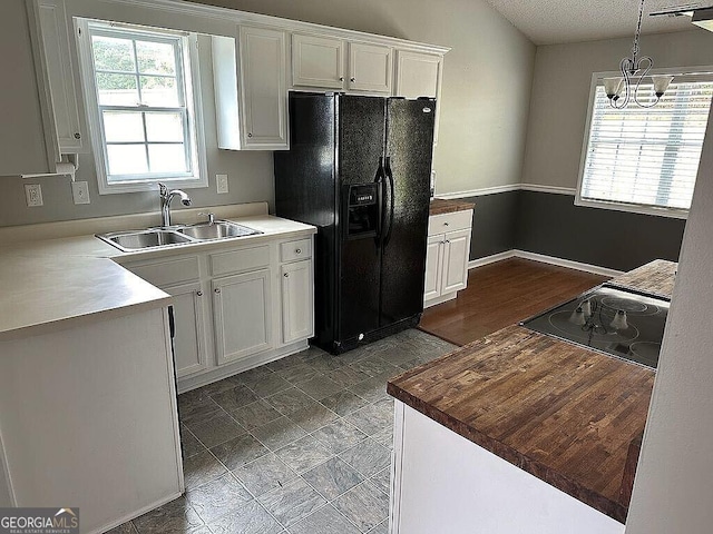 929 Wexford Way, Auburn, GA 30011 - kitchen with a sink, black appliances, white cabinets, plenty of natural light, and a textured ceiling