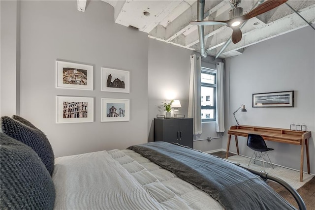 bedroom featuring baseboards and wood finished floors