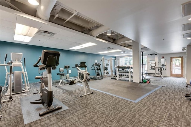 workout area featuring a drop ceiling, carpet flooring, and visible vents