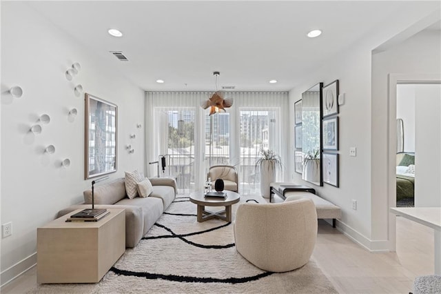 tiled living room with a notable chandelier