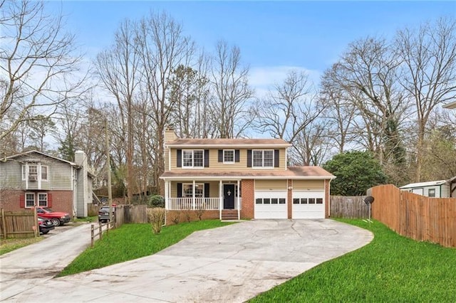 view of front of home with a garage, covered porch, and a front yard