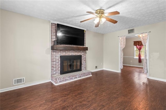 unfurnished living room featuring dark hardwood / wood-style flooring, ceiling fan, a textured ceiling, and a fireplace