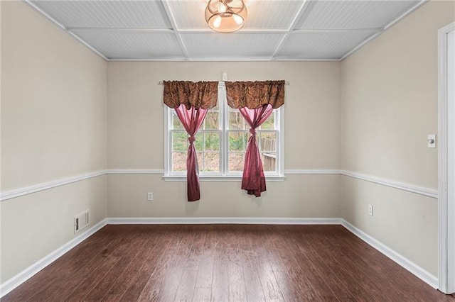 empty room with dark hardwood / wood-style flooring