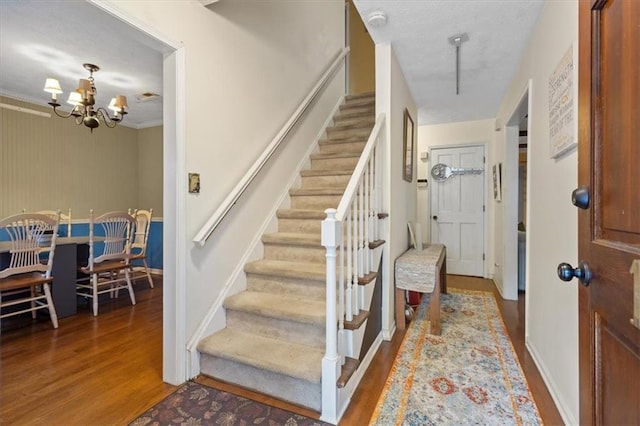 entrance foyer with hardwood / wood-style flooring and a chandelier