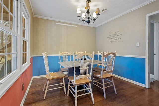 dining area featuring a chandelier, dark hardwood / wood-style flooring, a wealth of natural light, and crown molding