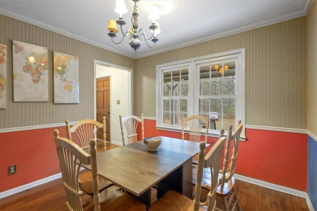 dining space with a chandelier, dark hardwood / wood-style floors, and crown molding