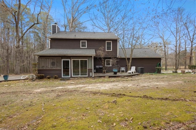 rear view of property featuring a sunroom, a yard, and cooling unit