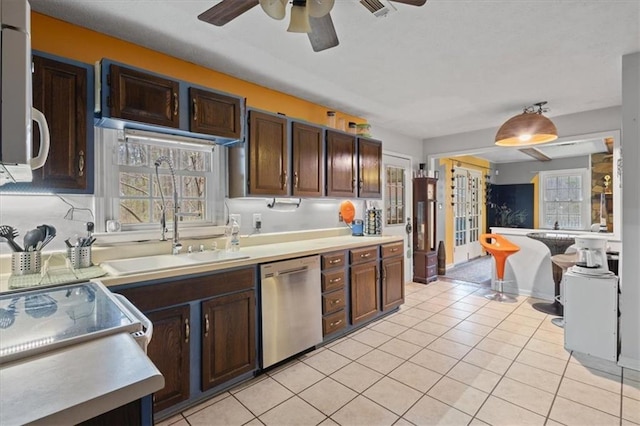 kitchen featuring dishwasher, light tile patterned floors, and dark brown cabinets