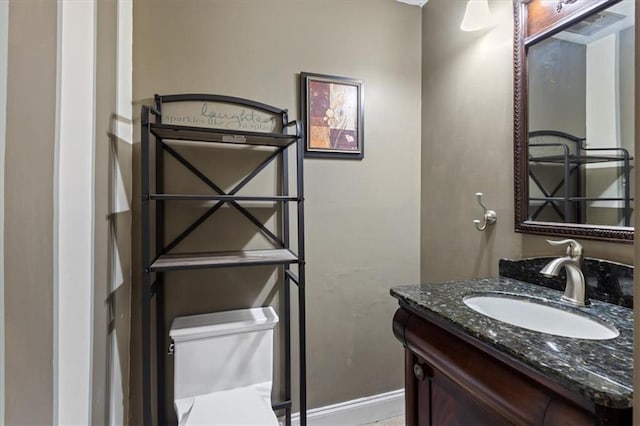 bathroom featuring vanity and toilet