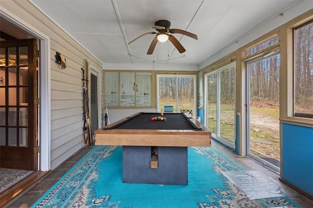 game room with wooden walls, ceiling fan, and pool table