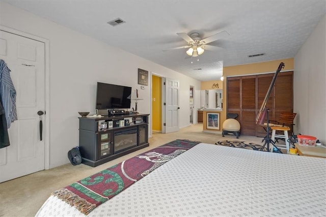 bedroom with light carpet and ceiling fan