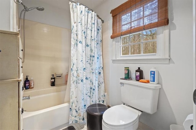 bathroom featuring shower / bath combo and toilet