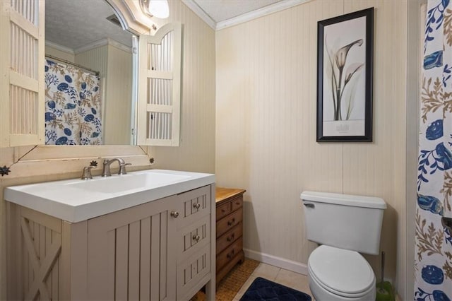 bathroom with tile patterned flooring, a textured ceiling, toilet, vanity, and ornamental molding