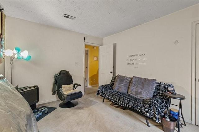 sitting room featuring carpet floors and a textured ceiling