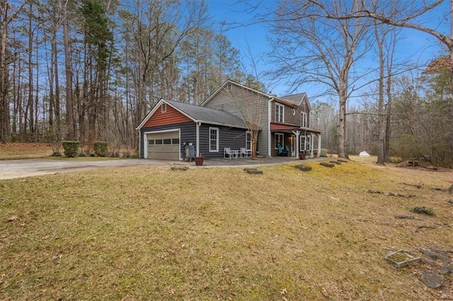 view of front facade featuring a front lawn, a porch, and a garage