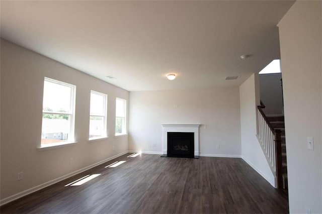 unfurnished living room featuring dark wood-type flooring