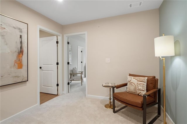 living area with light colored carpet