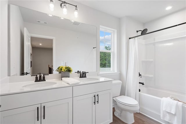 full bathroom featuring toilet, vanity, shower / bath combination with curtain, and hardwood / wood-style flooring