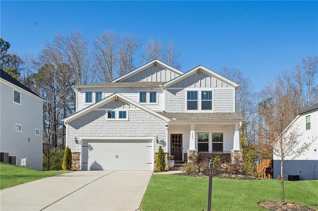 craftsman-style house with central AC unit, a garage, and a front lawn