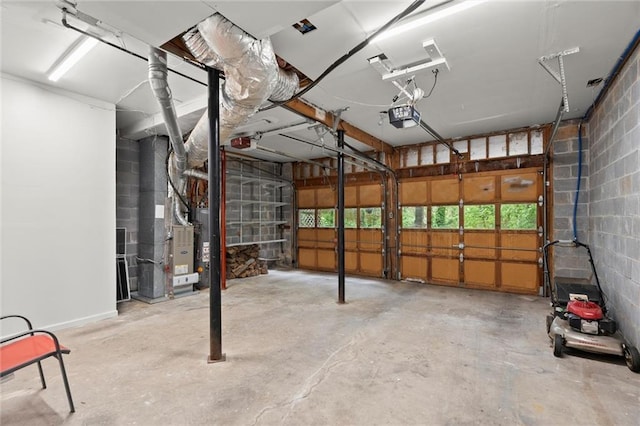 garage with concrete block wall and a garage door opener