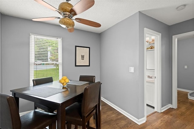 dining space featuring baseboards, ceiling fan, and wood finished floors