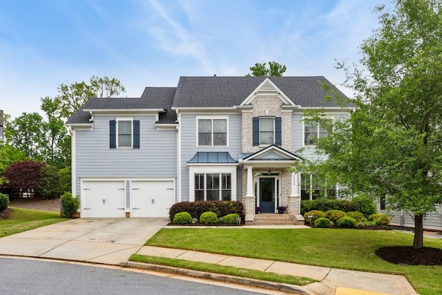 craftsman house with concrete driveway, a front yard, an attached garage, and a shingled roof