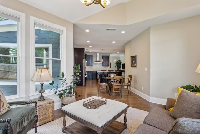 living room with wood finished floors, recessed lighting, baseboards, and a chandelier