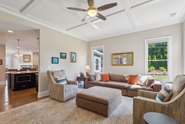 living room featuring coffered ceiling, wood finished floors, healthy amount of natural light, a ceiling fan, and recessed lighting