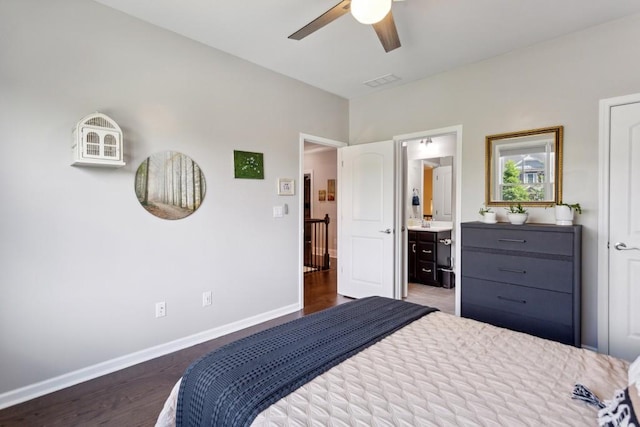 bedroom with baseboards, wood finished floors, ensuite bath, and ceiling fan