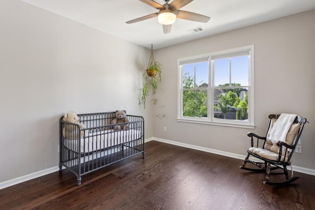 living area with wood finished floors, baseboards, and ceiling fan