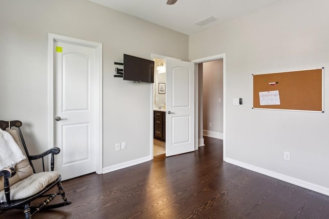 unfurnished room featuring dark wood-type flooring and baseboards