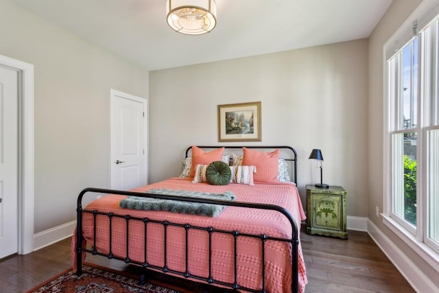 bedroom featuring wood finished floors and baseboards