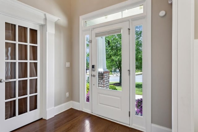 entryway featuring dark wood-type flooring and baseboards