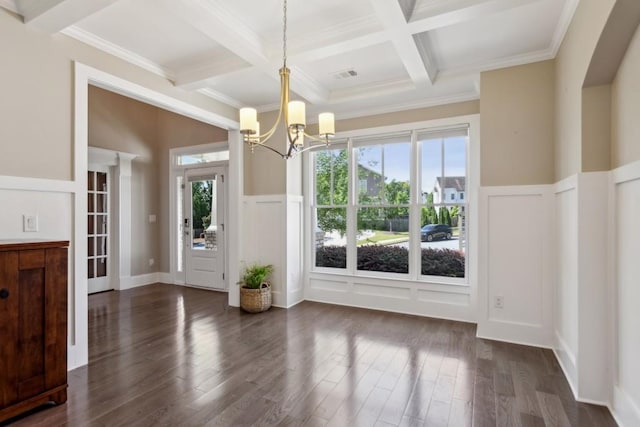 unfurnished dining area with a decorative wall, healthy amount of natural light, coffered ceiling, beamed ceiling, and a chandelier
